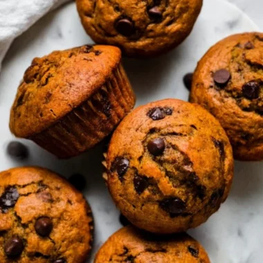 Delicious Pumpkin Chocolate Chip Muffins with Almond Butter on a wooden table