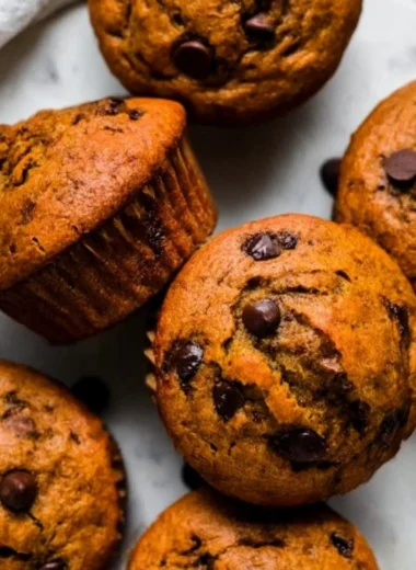 Delicious Pumpkin Chocolate Chip Muffins with Almond Butter on a wooden table