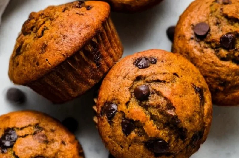 Delicious Pumpkin Chocolate Chip Muffins with Almond Butter on a wooden table