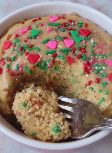 Bowl of Sugar Cookie Protein Baked Oats topped with colorful sprinkles