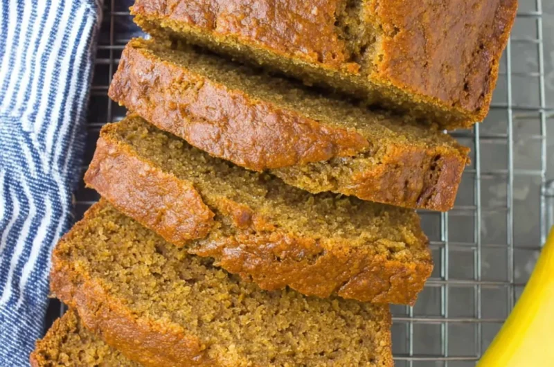 Slice of healthy banana bread on a wooden table