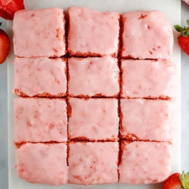 Delicious strawberry brownies made with a cake mix, topped with fresh strawberries.