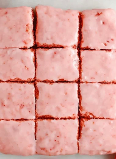 Delicious strawberry brownies made with a cake mix, topped with fresh strawberries.