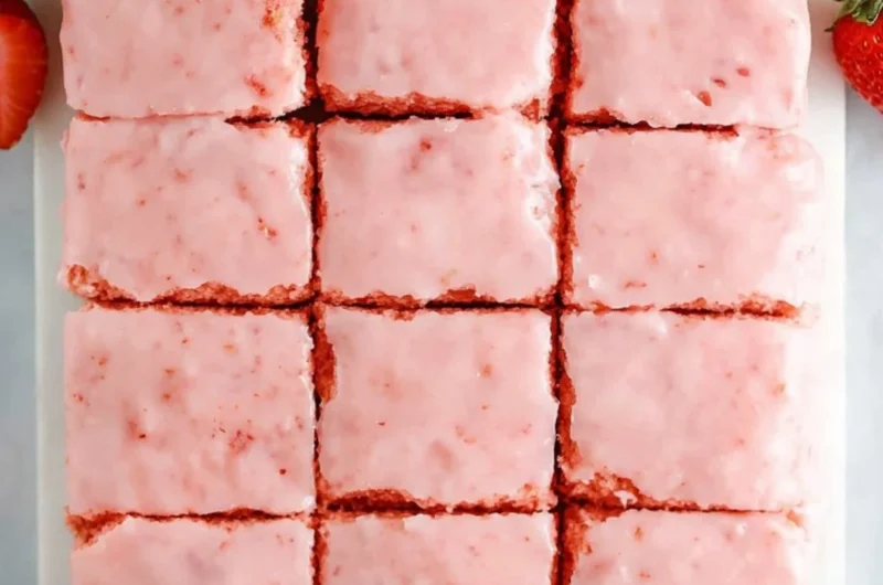 Delicious strawberry brownies made with a cake mix, topped with fresh strawberries.