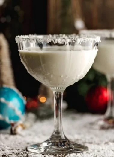 White Chocolate Snowflake Martini garnished with a snowflake rim and festive sprinkles.