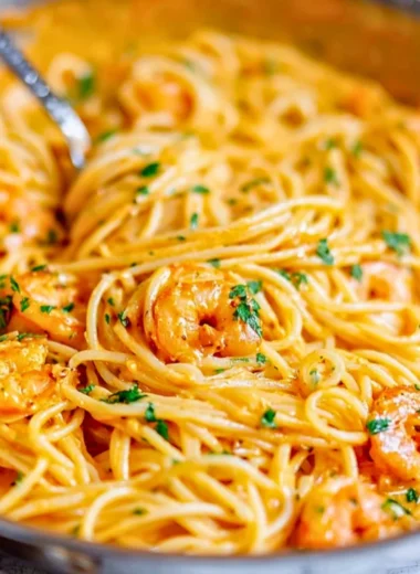 Plate of Bang Bang Shrimp Pasta garnished with herbs and chili flakes