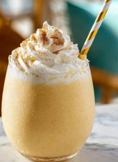 Delicious eggnog milkshake topped with whipped cream and nutmeg