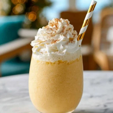 Delicious eggnog milkshake topped with whipped cream and a sprinkle of nutmeg.