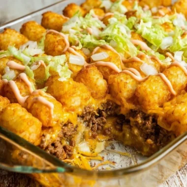 Delicious Big Mac Tater Tot casserole topped with melted cheese and garnished