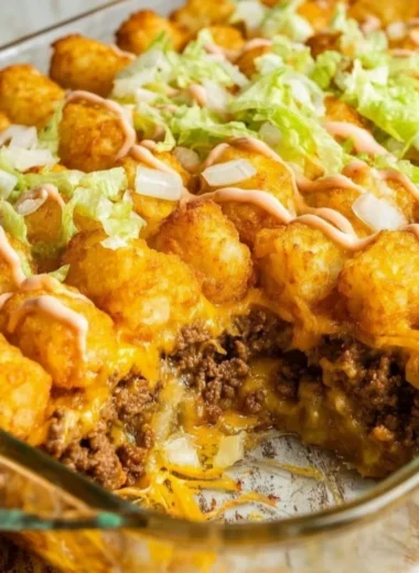 Delicious Big Mac Tater Tot casserole topped with melted cheese and garnished