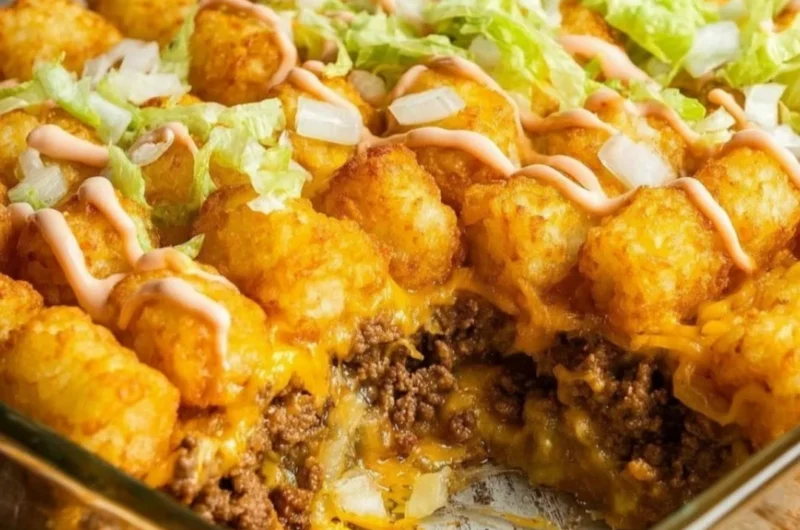 Delicious Big Mac Tater Tot casserole topped with melted cheese and garnished
