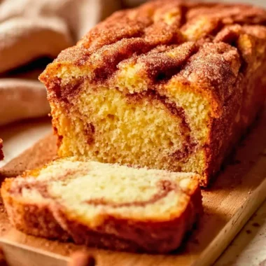 Buttery snickerdoodle bread slice on a cooling rack