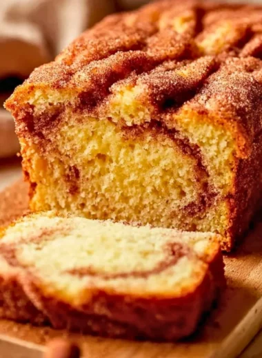 Buttery snickerdoodle bread slice on a cooling rack