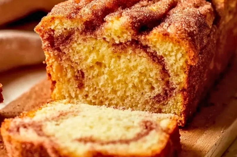 Buttery snickerdoodle bread slice on a cooling rack