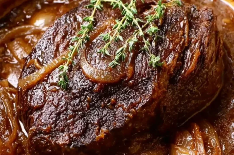 Delicious Caramelized French Onion Pot Roast served with herbs and vegetables.