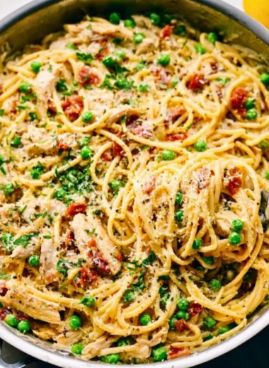 Creamy chicken carbonara pasta dish garnished with parsley.