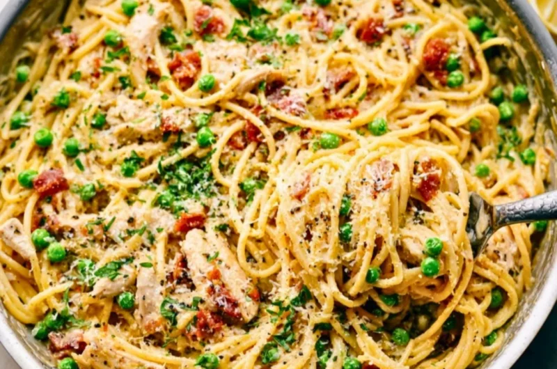 Creamy chicken carbonara pasta dish garnished with parsley.