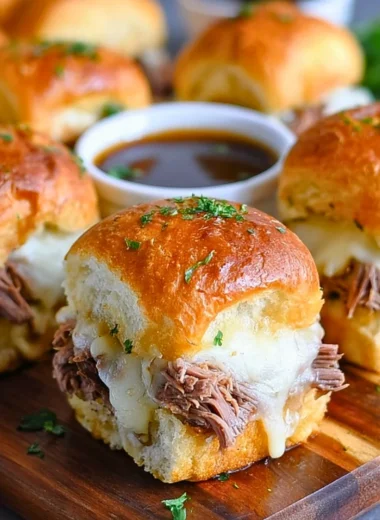 Delicious French Dip Sliders served with a savory dipping sauce.