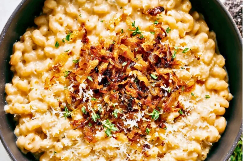 Bowl of delicious French onion macaroni cheese topped with crispy onions