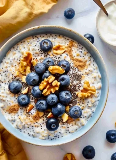 High protein blueberry overnight oats topped with yogurt and fresh blueberries