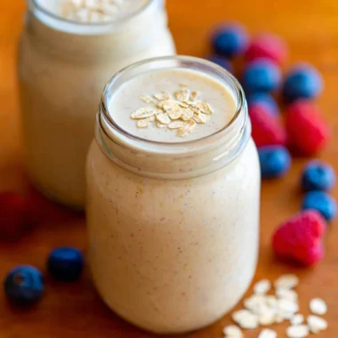 Healthy oatmeal smoothie in a glass with fruits and oats