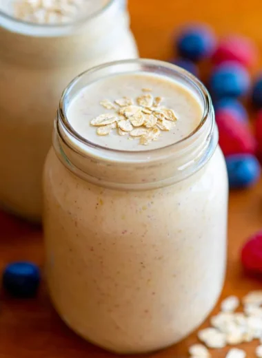 Healthy oatmeal smoothie in a glass with fruits and oats