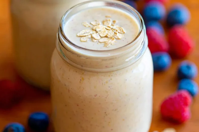 Healthy oatmeal smoothie in a glass with fruits and oats