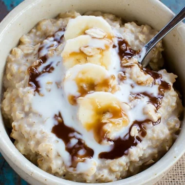 A nutritious oatmeal smoothie with fruits and toppings in a glass