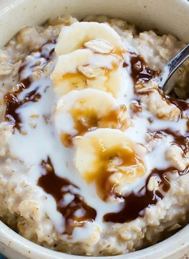 A nutritious oatmeal smoothie with fruits and toppings in a glass