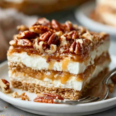 Pecan pie lasagna with layers of creamy filling and crunchy pecans