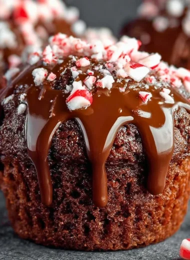 Freshly baked peppermint hot chocolate muffins topped with chocolate chips.