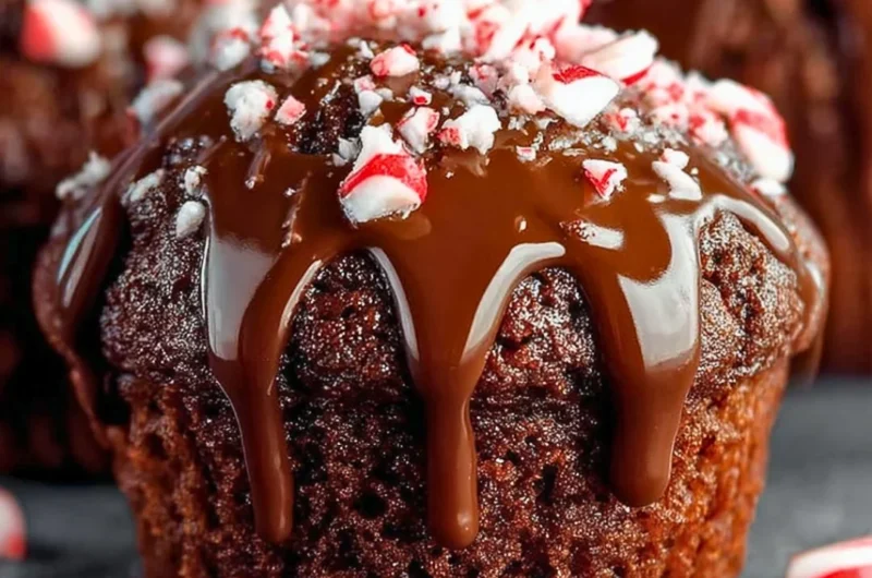 Freshly baked peppermint hot chocolate muffins topped with chocolate chips.
