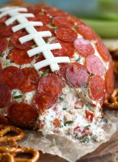 Pepperoni pizza football cheese ball served at a party