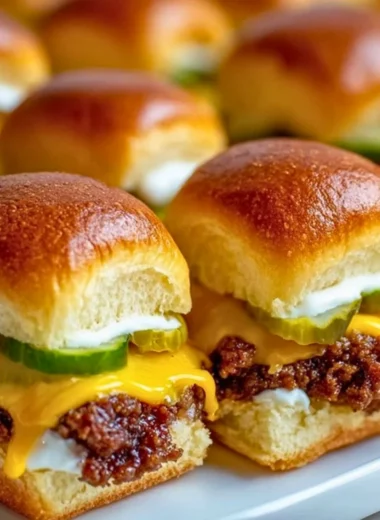 Delicious sheetpan burger sliders served on a platter with toppings