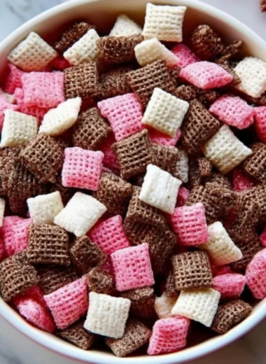 Sweet Easy Neapolitan Puppy Chow Snack Mix in a colorful bowl