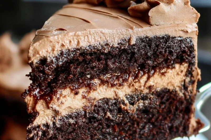 Delicious vegan chocolate cake topped with vegan frosting and fresh berries