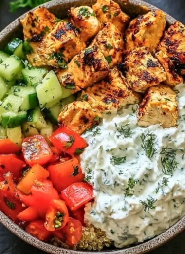 Chicken Tzatziki Bowls topped with fresh vegetables and creamy sauce