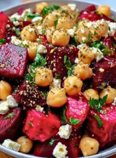 Chickpea salad with roasted beets and crumbled feta cheese on a plate