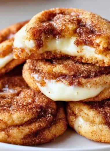 Delicious Cinnamon Roll Cheesecake Cookies on a plate, drizzled with icing