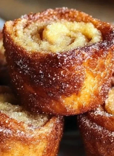 Delicious Cinnamon Roll French Toast Bites served with syrup and berries