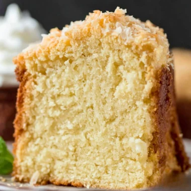 Delicious Coconut Cream Cheese Pound Cake topped with coconut flakes
