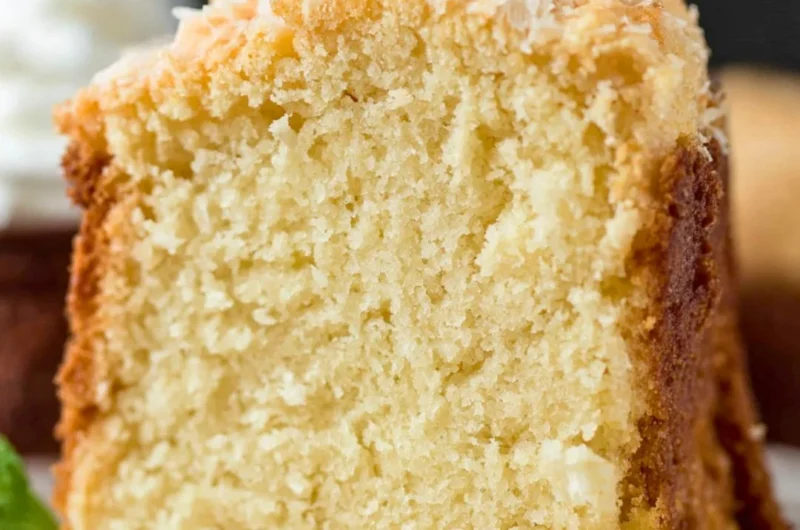 Delicious Coconut Cream Cheese Pound Cake topped with coconut flakes