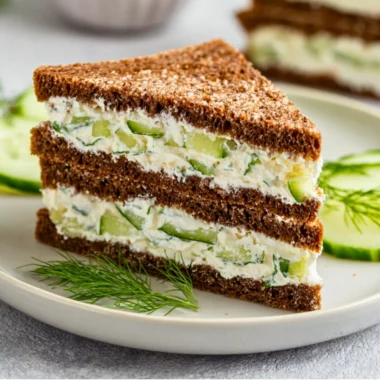 Plate of fresh cucumber sandwiches with herbs and butter for a light snack