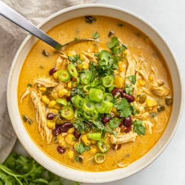 Bowl of easy chicken poblano soup garnished with cilantro and lime.