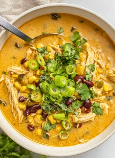 Bowl of easy chicken poblano soup garnished with cilantro and lime.