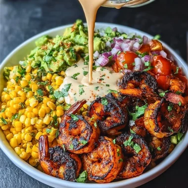 Delicious grilled shrimp bowl with avocado, corn salsa, and creamy garlic sauce