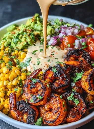 Delicious grilled shrimp bowl with avocado, corn salsa, and creamy garlic sauce