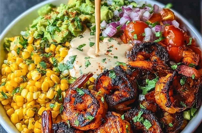 Delicious grilled shrimp bowl with avocado, corn salsa, and creamy garlic sauce