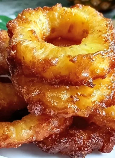 Delicious pineapple fritters topped with powdered sugar and served with a tropical dip