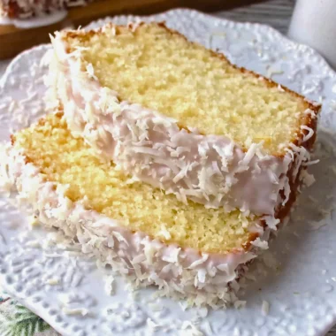 Homemade coconut pound cake with a moist texture and coconut flakes